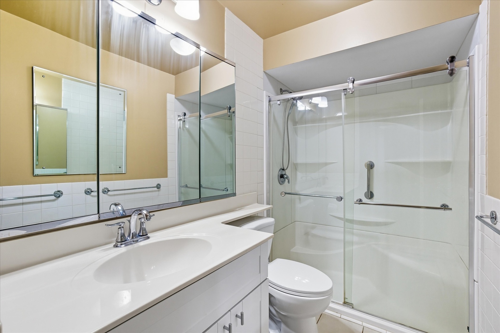 5855 North Sheridan Road, Unit 9F Chicago, IL 60660 - Photo 9 of 23 a bathroom with a sink toilet vanity and shower