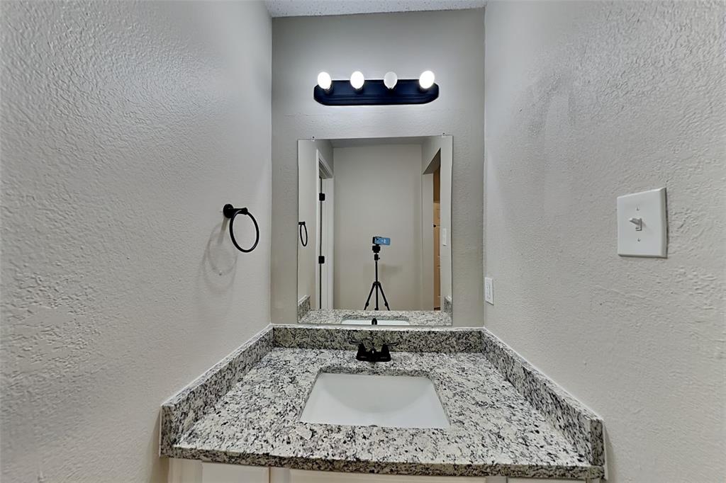 2224 Red Maple Road Flower Mound, TX 75022 - Photo 17 of 22 a view of a hallway with a chandelier