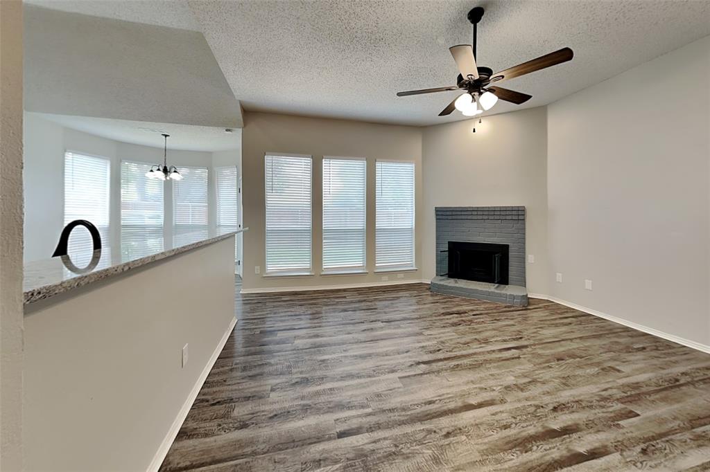 2224 Red Maple Road Flower Mound, TX 75022 - Photo 3 of 22 a view of an empty room with chandelier fan and wooden floor