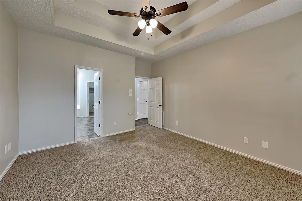 2224 Red Maple Road Flower Mound, TX 75022 - Photo 8 of 22 an empty room with chandelier fan and windows