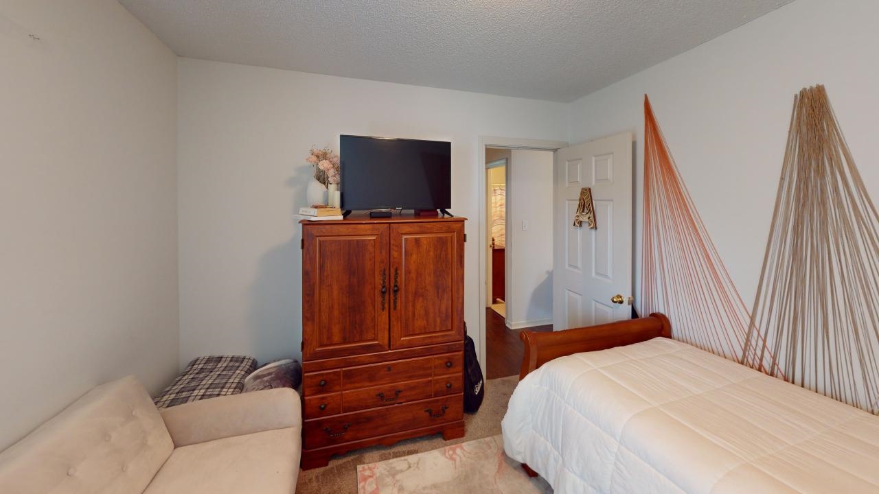 6916 Manslick Road Cordova, TN 38018 - Photo 11 of 17 a bedroom with a bed and flat screen tv