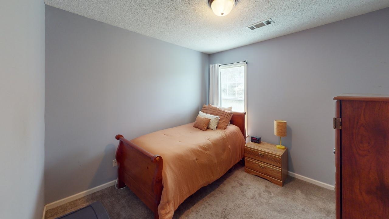 6916 Manslick Road Cordova, TN 38018 - Photo 12 of 17 a bedroom with a bed and window