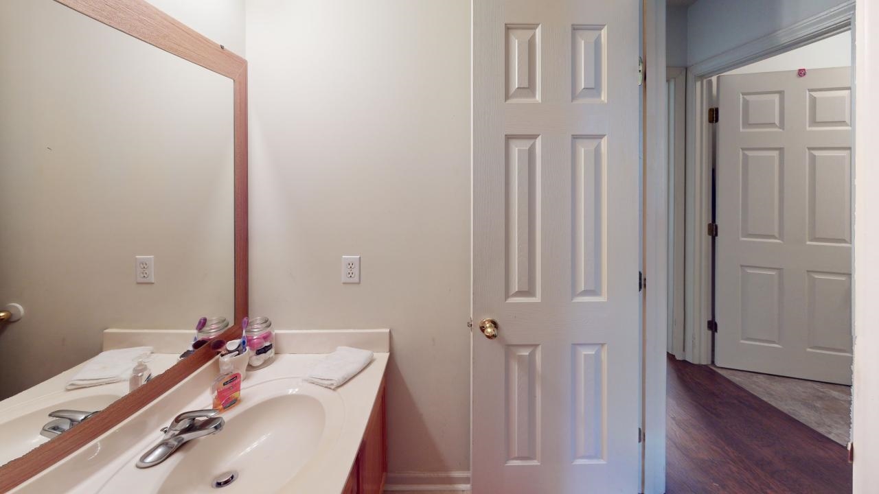 6916 Manslick Road Cordova, TN 38018 - Photo 13 of 17 a bathroom with a sink and a mirror