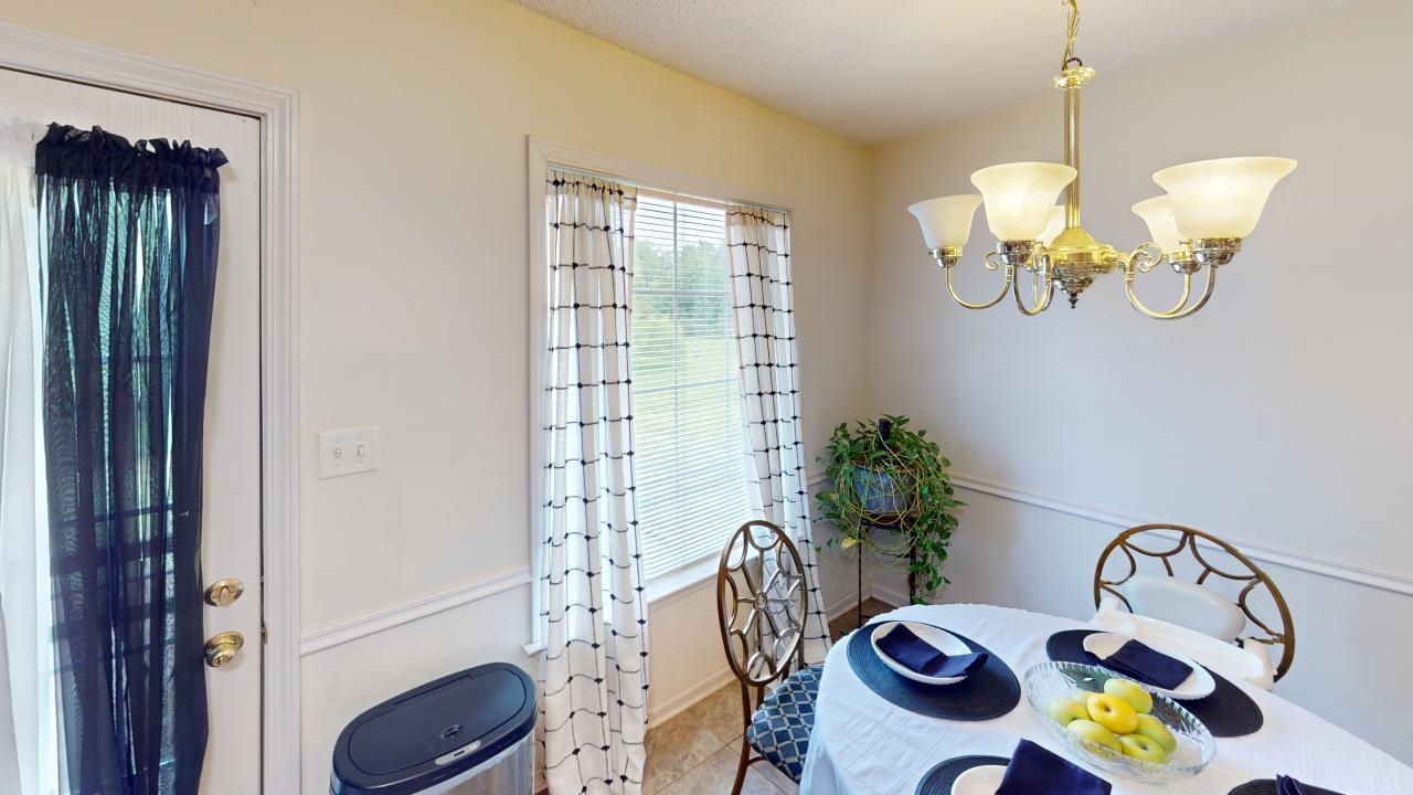 6916 Manslick Road Cordova, TN 38018 - Photo 6 of 17 a table with potted plants and a chandelier