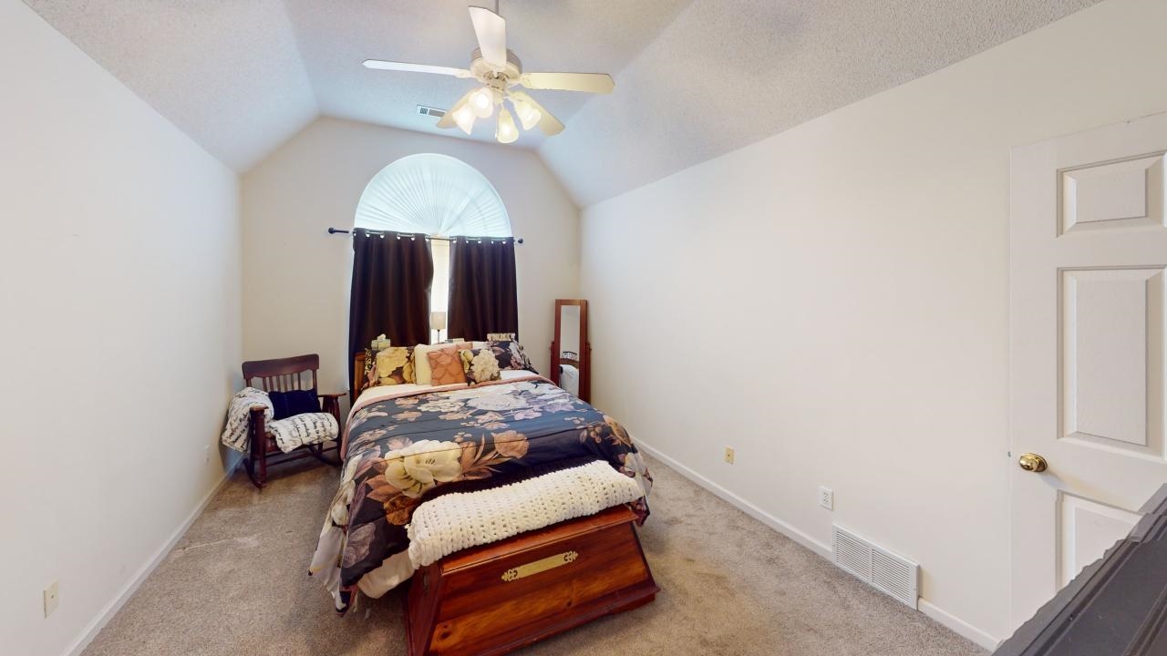 6916 Manslick Road Cordova, TN 38018 - Photo 7 of 17 a bedroom with a bed and a chandelier