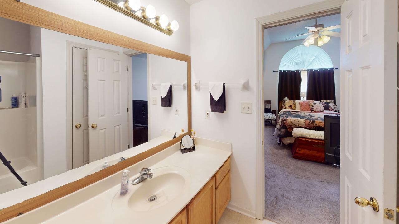 6916 Manslick Road Cordova, TN 38018 - Photo 8 of 17 a en suite bathroom with a double vanity sink and a mirror