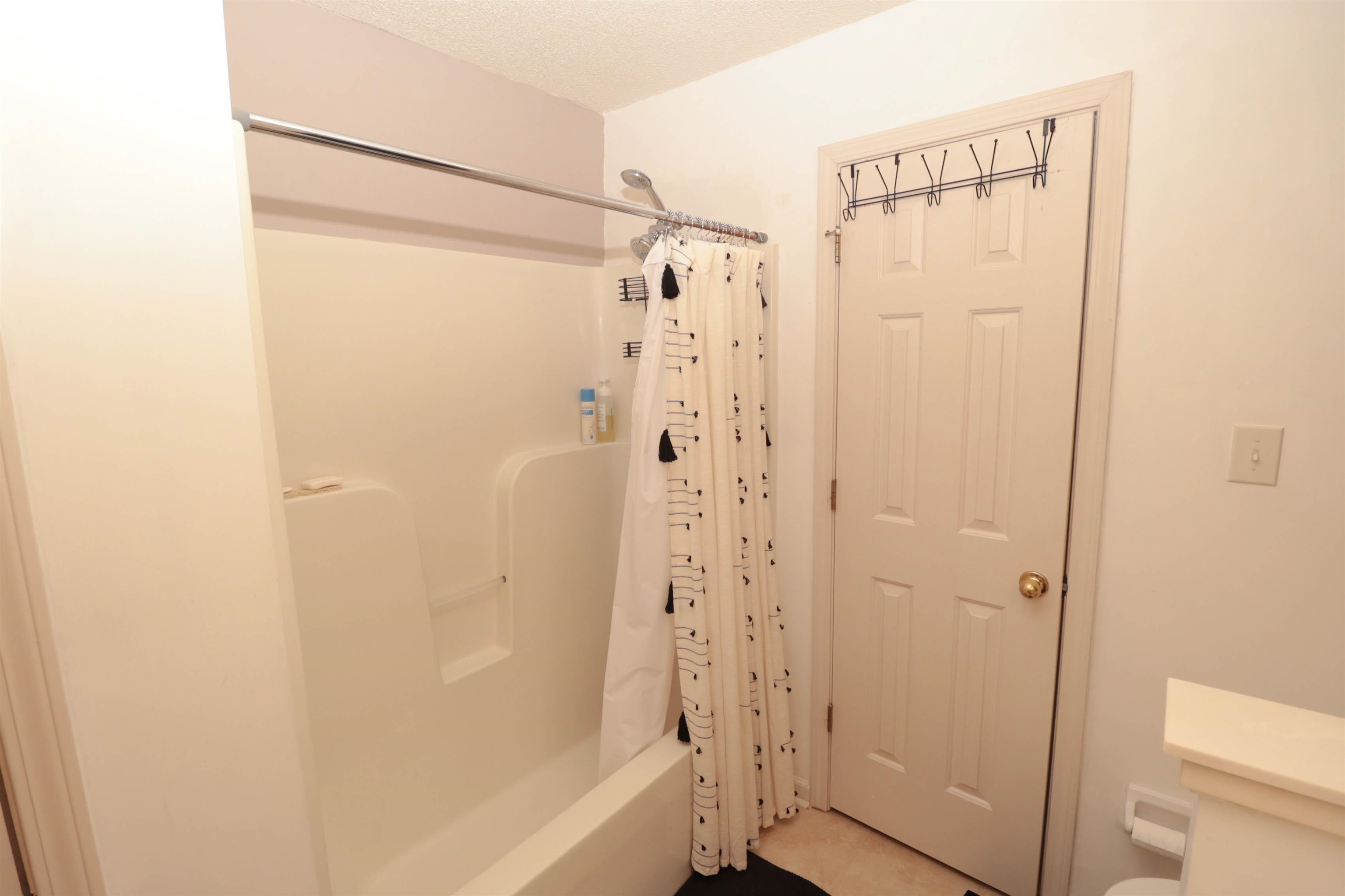 6916 Manslick Road Cordova, TN 38018 - Photo 9 of 17 a bathroom with a bathtub and a shower