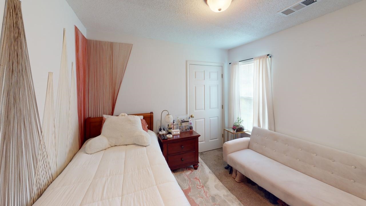 6916 Manslick Road Cordova, TN 38018 - Photo 10 of 17 a bed room with a bed and a couch