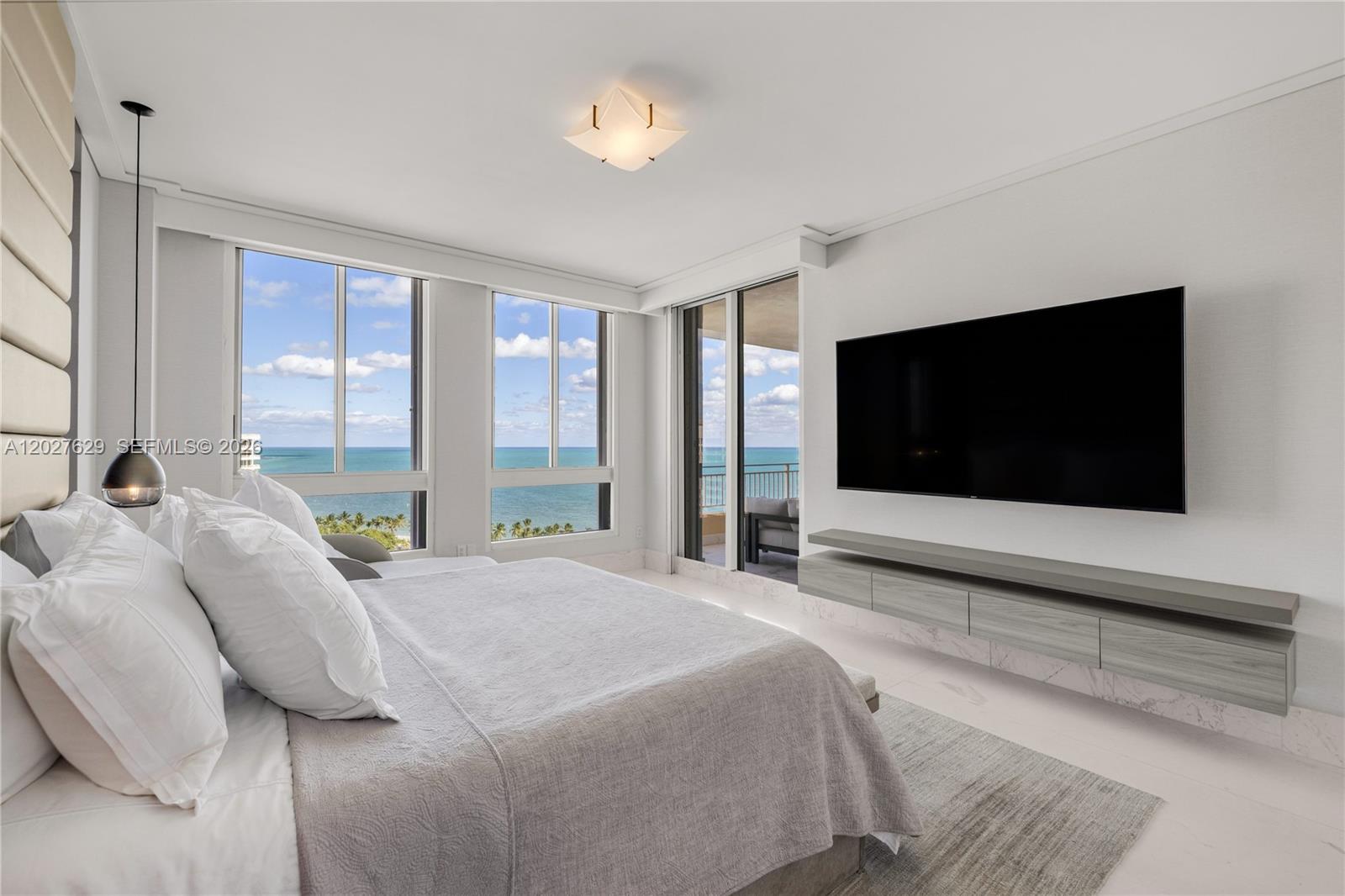 799 Crandon Boulevard, Unit PH8 Key Biscayne, FL 33149 - Photo 10 of 47 a bedroom with a bed and a flat screen tv