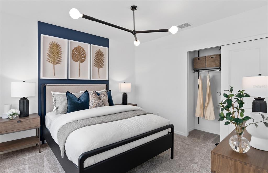 10382 Evening Horizon Street Orlando, FL 32829 - Photo 18 of 26 a bedroom with a bed and a potted plant