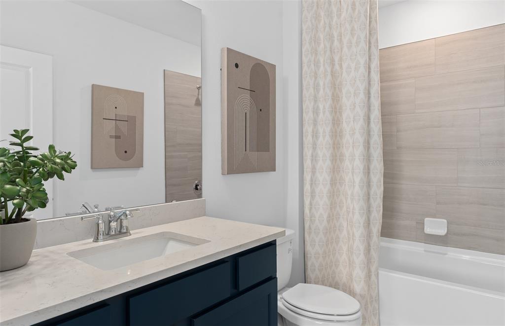 10382 Evening Horizon Street Orlando, FL 32829 - Photo 20 of 26 a bathroom with a sink a toilet and shower