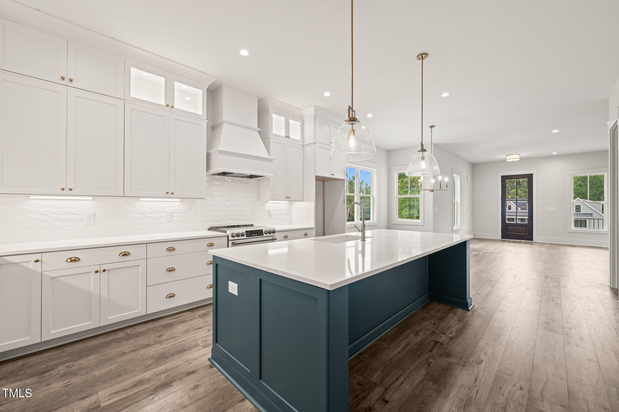 250 Pilot Ridge Road Zebulon, NC 27597 - Photo 12 of 43 a large kitchen with stainless steel appliances kitchen island granite countertop a large island in the center