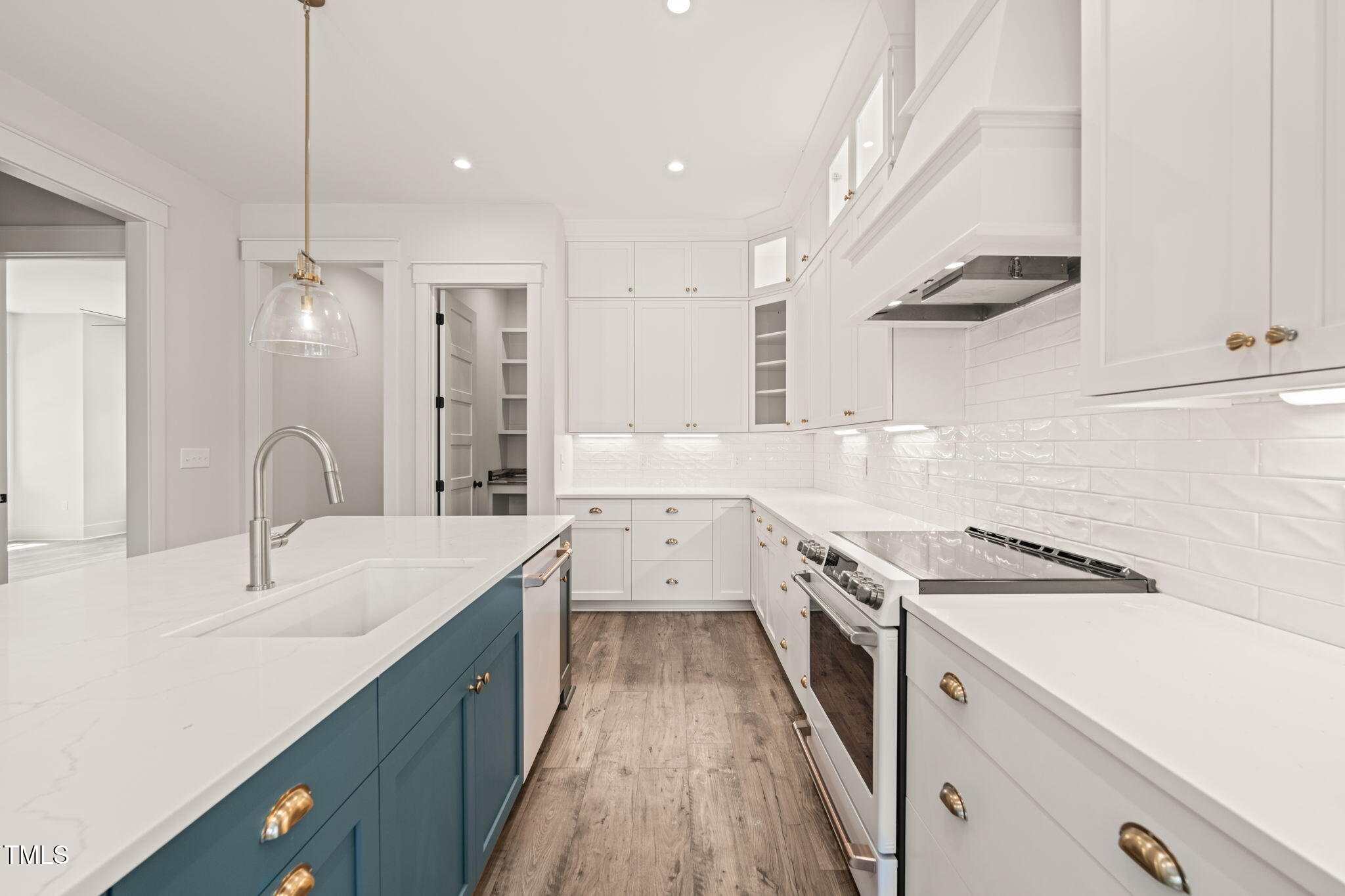 250 Pilot Ridge Road Zebulon, NC 27597 - Photo 13 of 43 a kitchen with a sink dishwasher a stove a refrigerator and white cabinets with wooden floor
