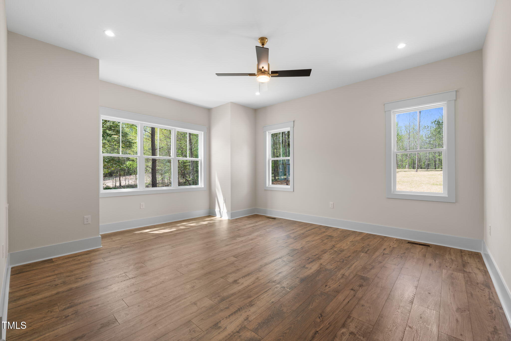 250 Pilot Ridge Road Zebulon, NC 27597 - Photo 16 of 43 a view of an empty room with wooden floor and a window