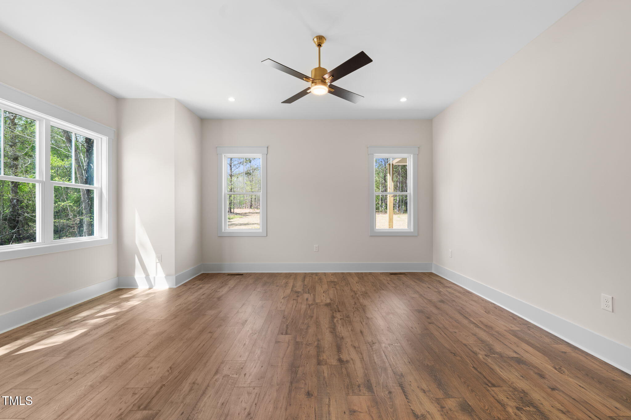 250 Pilot Ridge Road Zebulon, NC 27597 - Photo 17 of 43 a view of empty room with wooden floor and fan