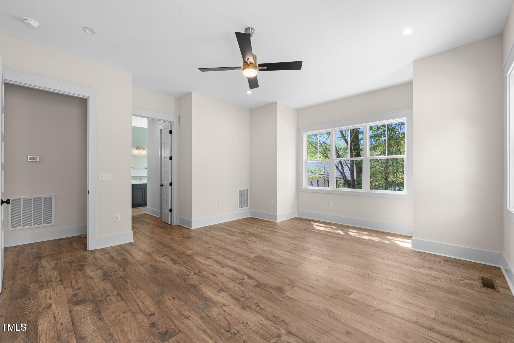 250 Pilot Ridge Road Zebulon, NC 27597 - Photo 18 of 43 a view of an empty room with wooden floor and a window