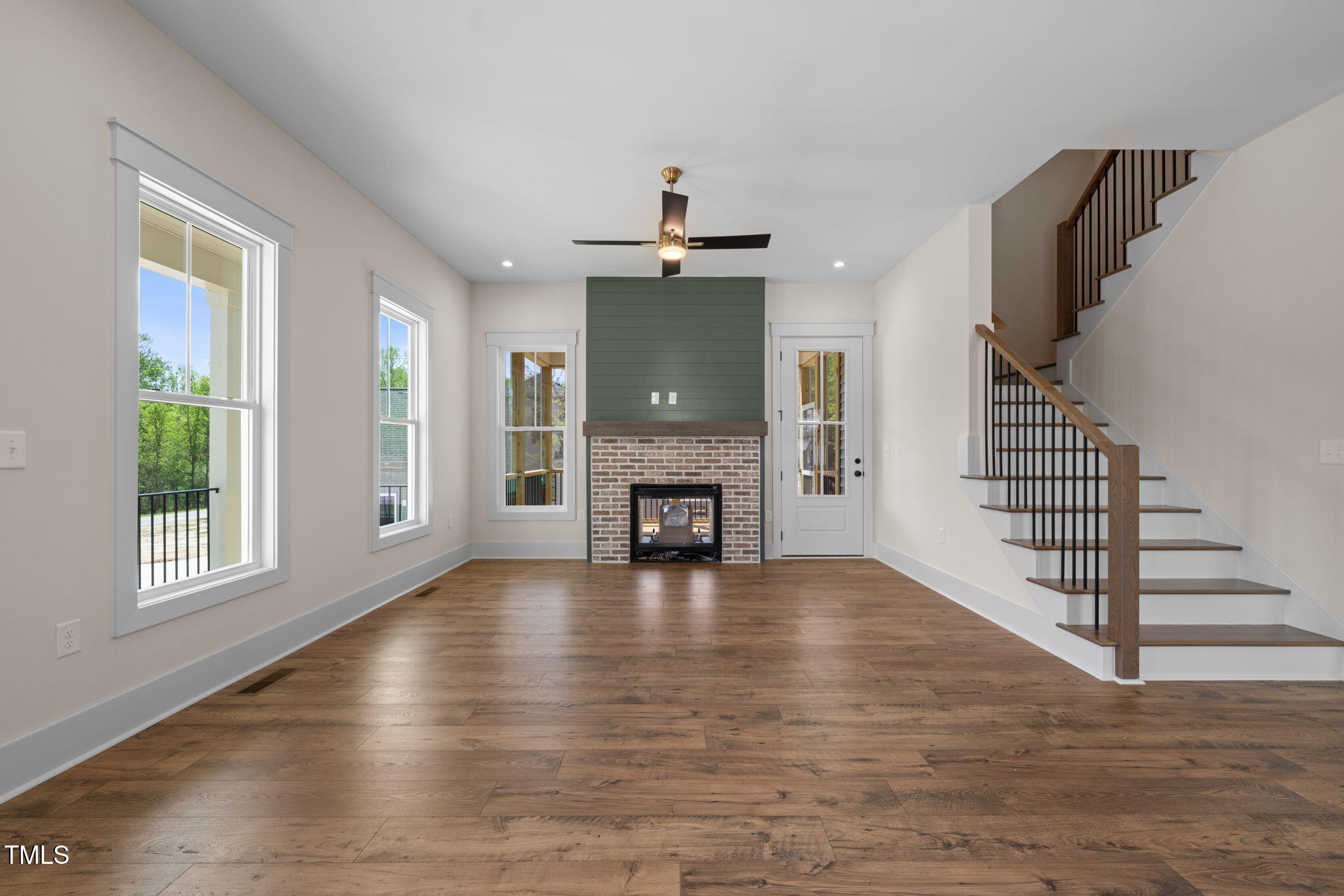 250 Pilot Ridge Road Zebulon, NC 27597 - Photo 4 of 43 a view of an empty room with wooden floor fireplace and a window