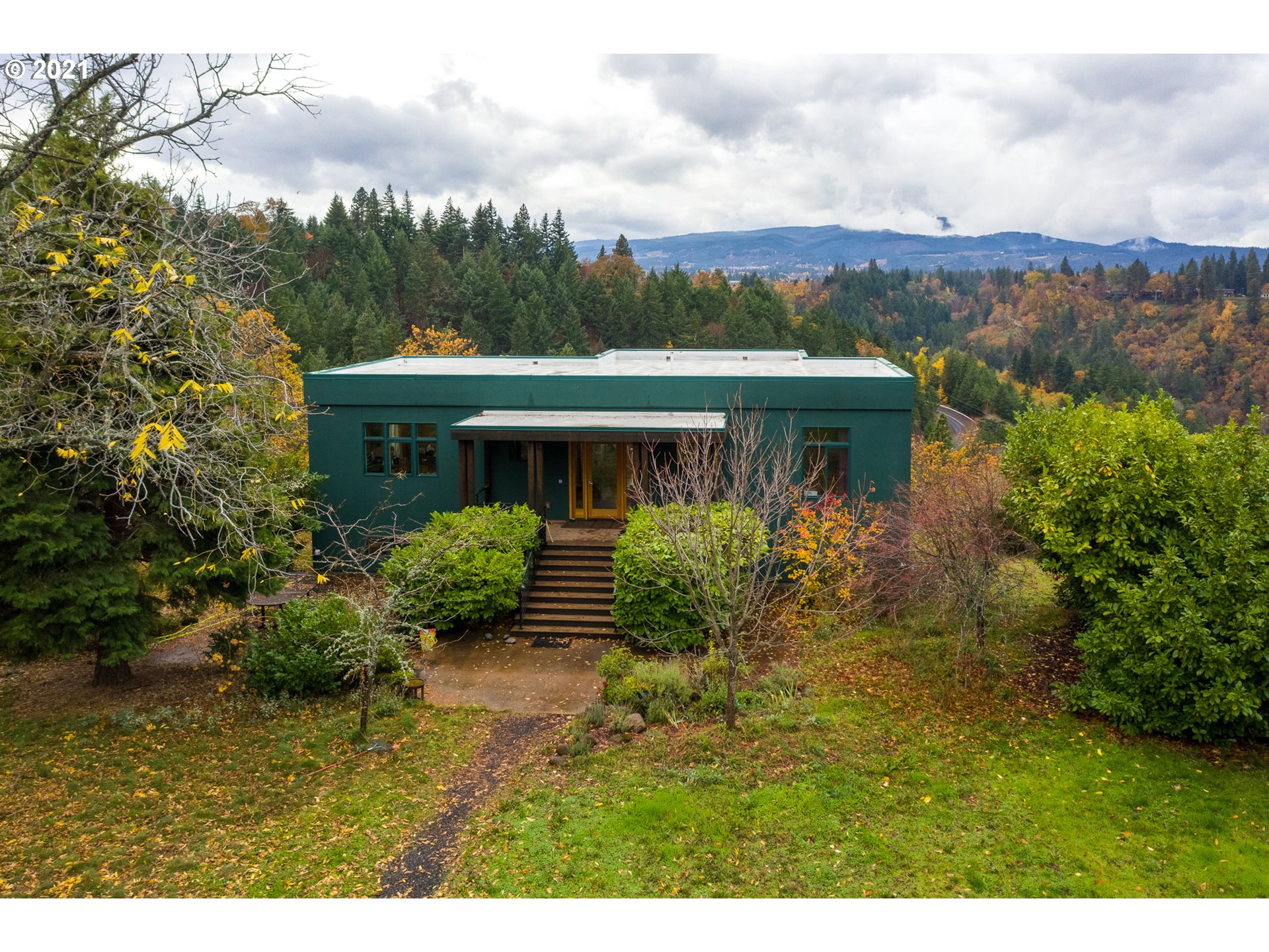 550 Highline Road Hood River, OR 97031 - Photo 2 of 31 a view of a white house with a big yard and large trees