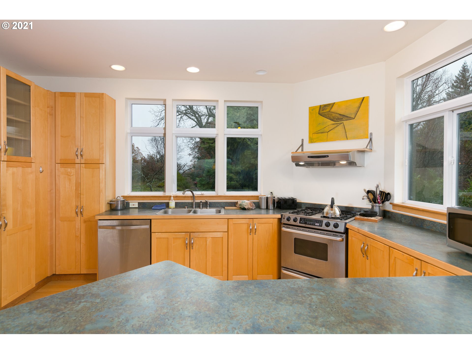 550 Highline Road Hood River, OR 97031 - Photo 15 of 31 a kitchen with stainless steel appliances granite countertop a stove a sink and a microwave