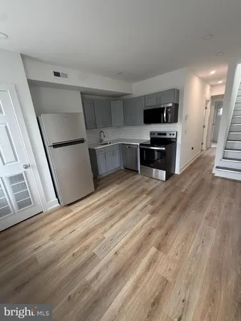 a view of a kitchen with microwave and cabinets