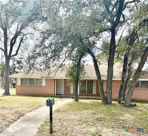 a view of a house with a yard covered with snow