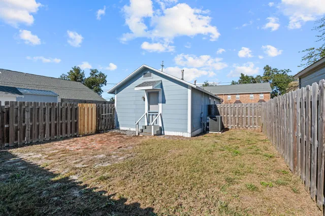 a backyard of a house with wooden fence