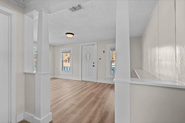 a view of a livingroom with wooden floor and window