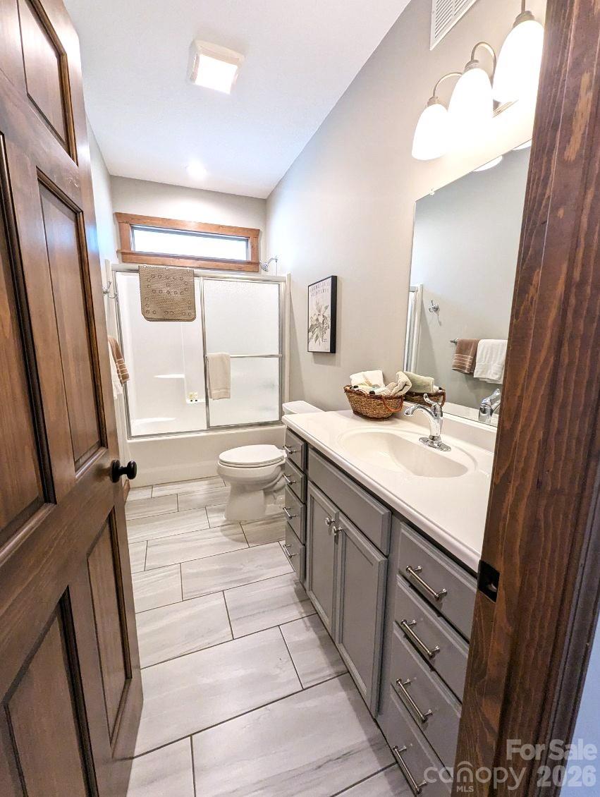 10 Rio Bravo Drive, Unit 4 Sylva, NC 28779 - Photo 27 of 33 a bathroom with a sink a mirror and a bath tub