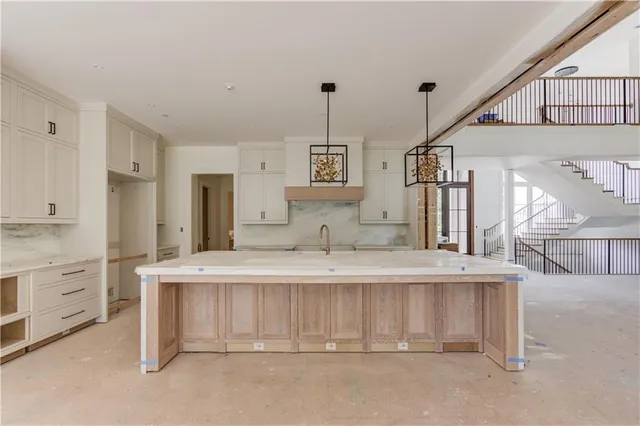 a spacious bathroom with a sink and a mirror