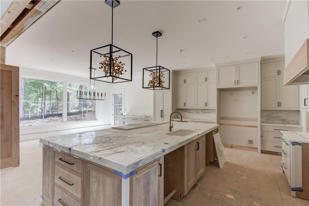 4635 Whitestone Way Suwanee, GA 30024 - Photo 12 of 27 a kitchen with a stove a refrigerator a sink and dishwasher