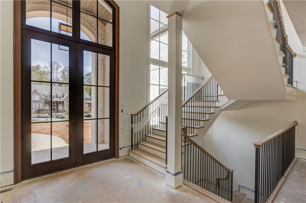 4635 Whitestone Way Suwanee, GA 30024 - Photo 7 of 27 a view of staircase with lots of windows and white walls