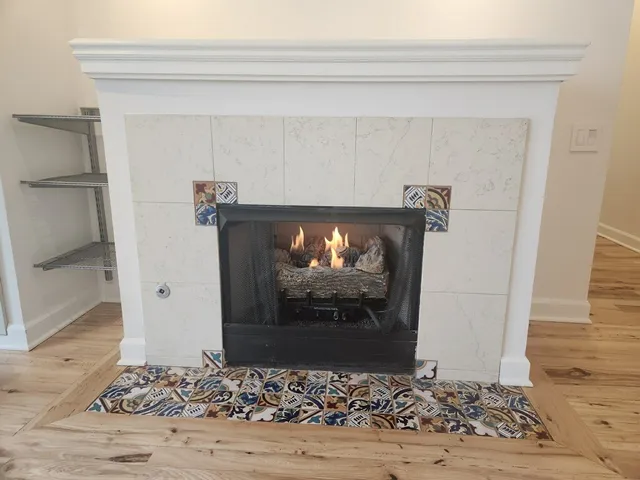 a kitchen with granite countertop a refrigerator and a stove top oven