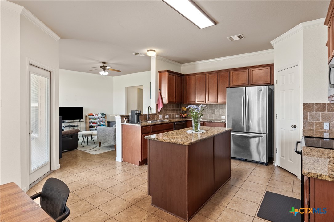 305 Brunswick Temple, TX 76502 - Photo 27 of 28 a kitchen with a refrigerator a sink dishwasher and a refrigerator