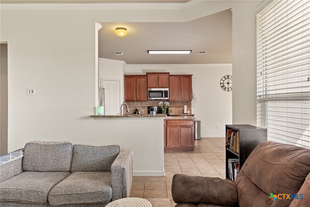 305 Brunswick Temple, TX 76502 - Photo 8 of 28 a living room with furniture a kitchen view and a window