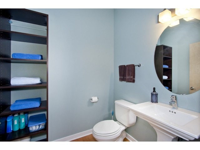1842 West Irving Park Road, Unit 202 Chicago, IL 60613 - Photo 18 of 20 a bathroom with a sink a toilet and a mirror
