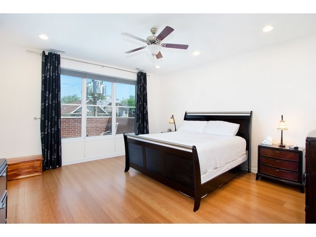 1842 West Irving Park Road, Unit 202 Chicago, IL 60613 - Photo 6 of 20 a bedroom with a bed and a large window