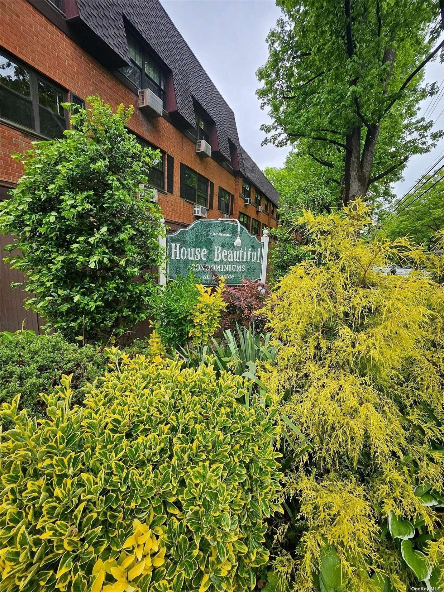 a yellow building with trees in front of it