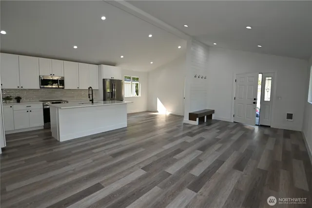 a view of kitchen with microwave and refrigerator