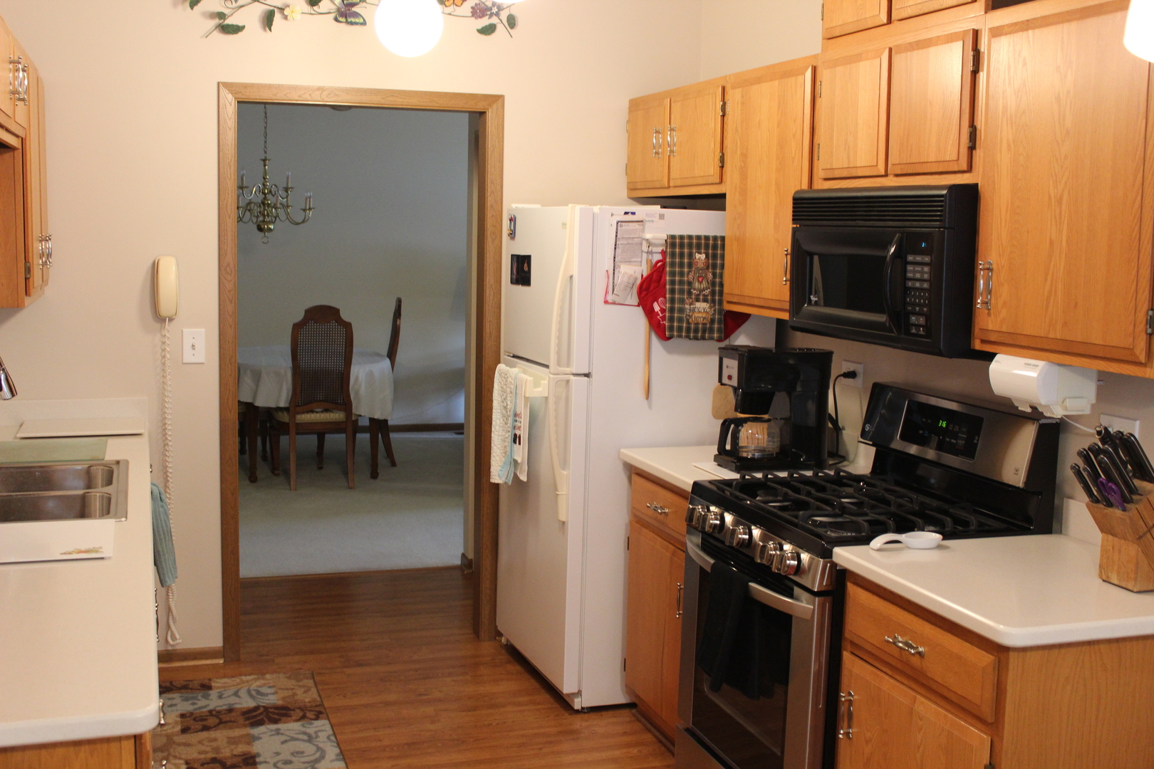 737 Alice Place Elgin, IL 60123 - Photo 7 of 28 a kitchen with a refrigerator and a stove top oven