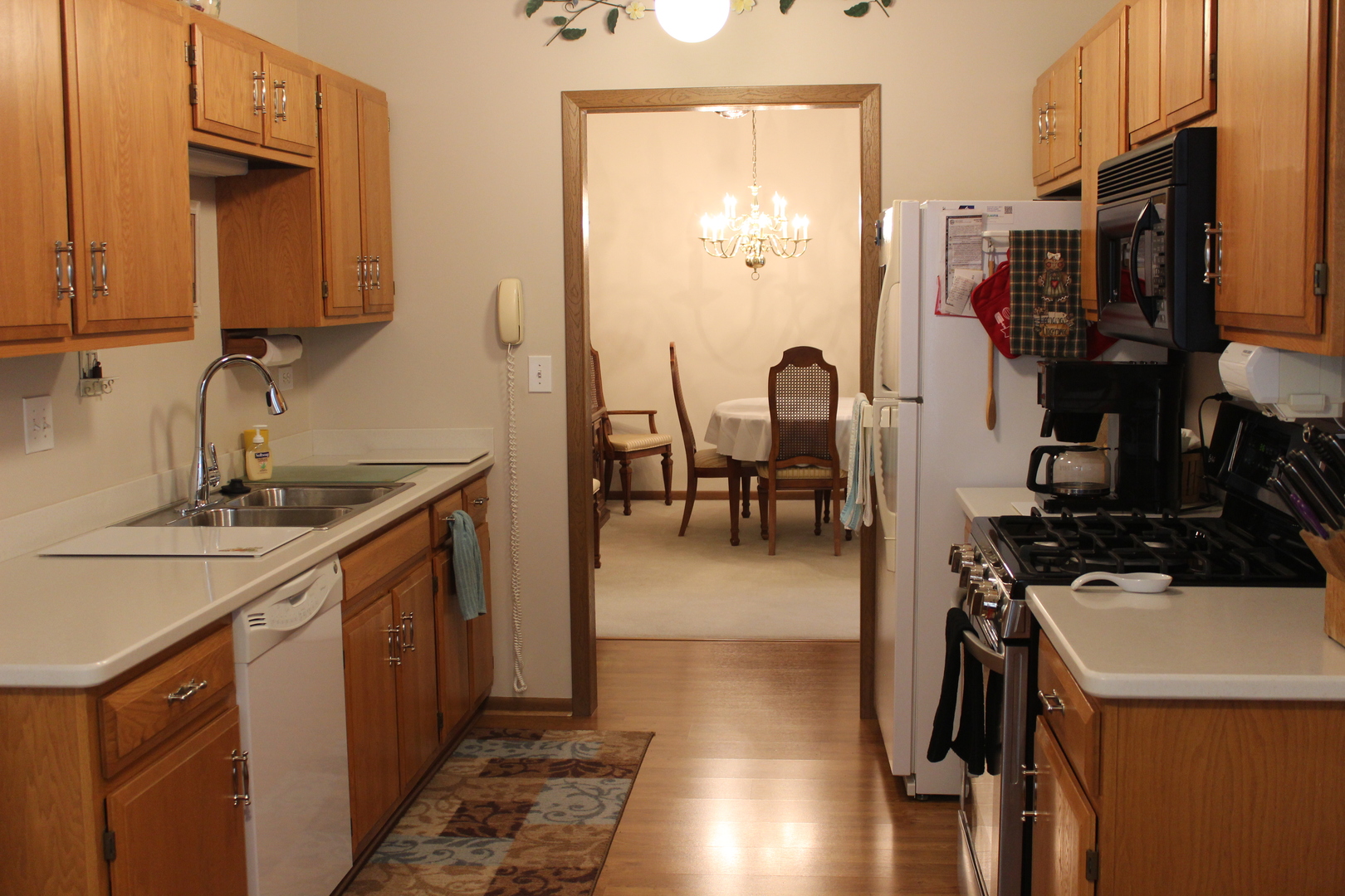 737 Alice Place Elgin, IL 60123 - Photo 8 of 28 a kitchen with sink refrigerator and cabinets