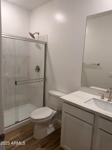 a bathroom with a toilet a sink and shower