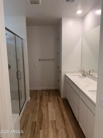 a bathroom with a sink a mirror and a shower