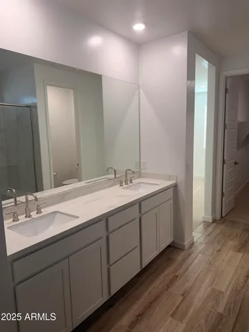 a bathroom with double vanity sink and a mirror