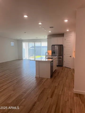 a kitchen with stainless steel appliances wooden floors and wooden cabinets
