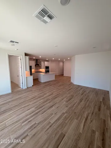 a view of a room with wooden floor