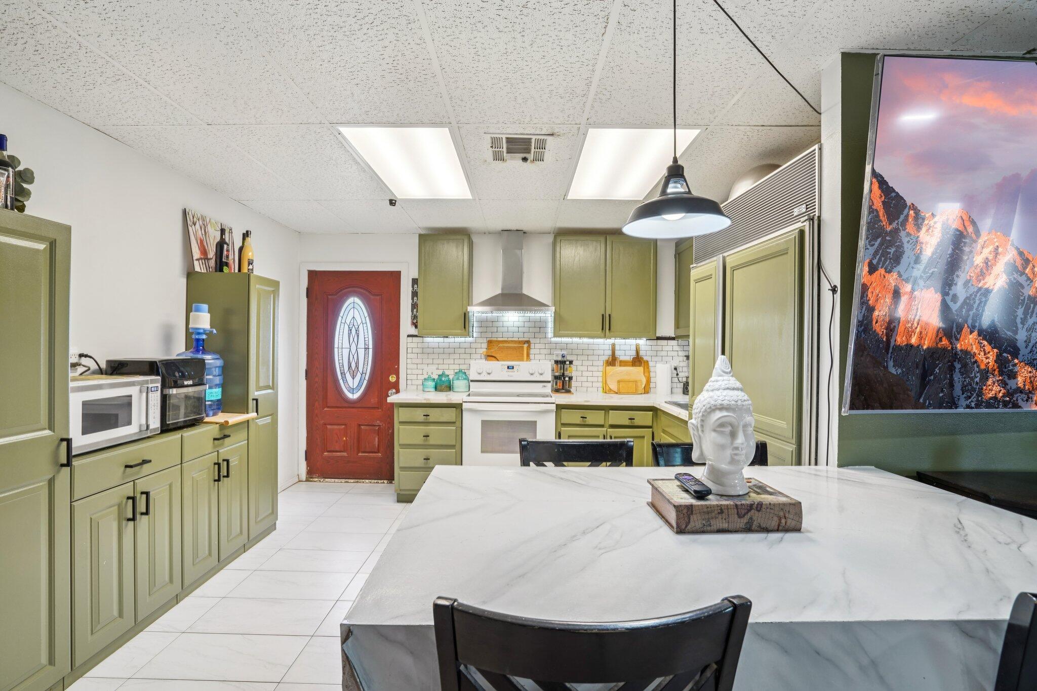 2154 Riviera Circle Thermal, CA 92274 - Photo 13 of 43 a living room with furniture a flat screen tv and kitchen view