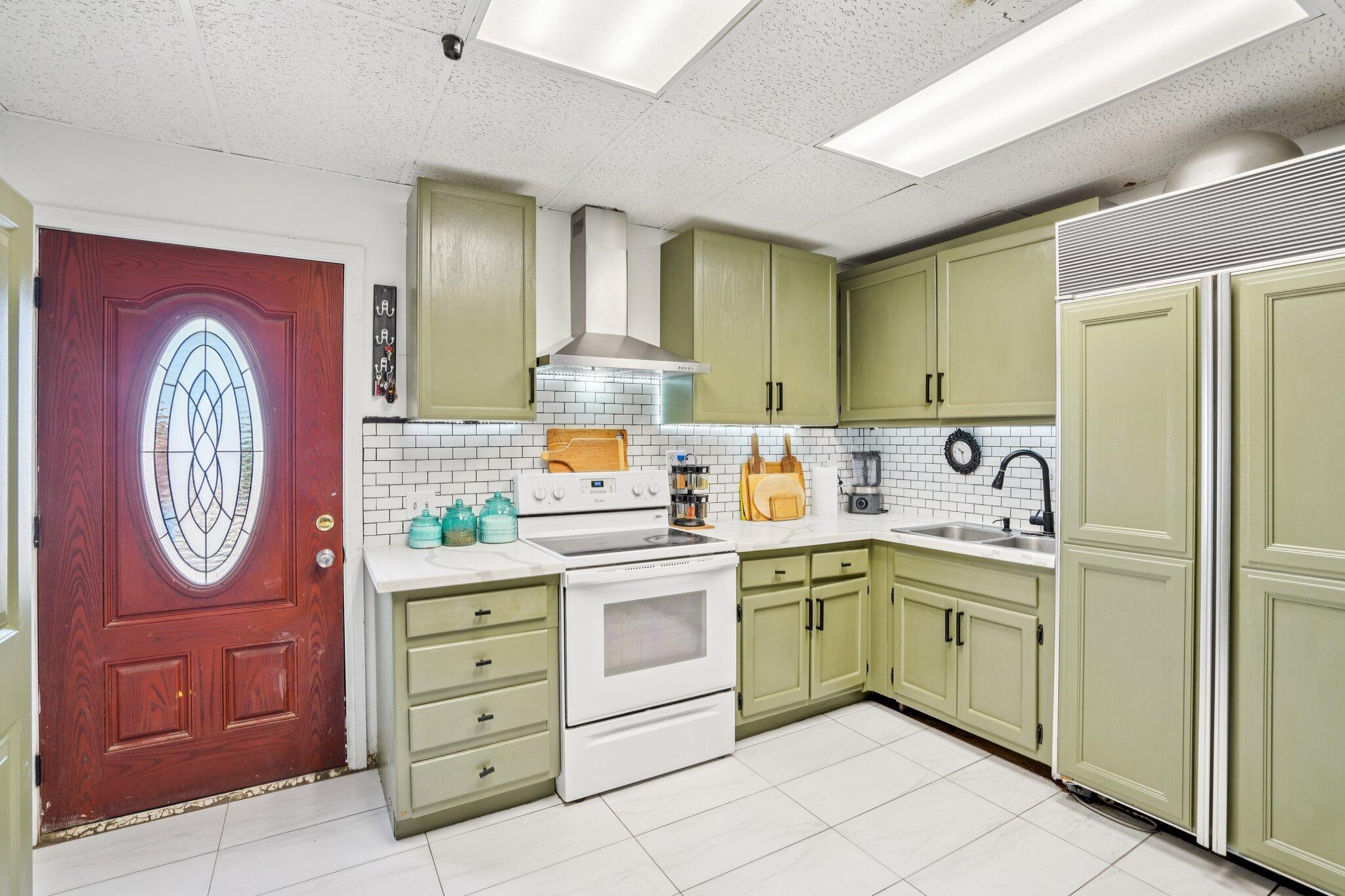 2154 Riviera Circle Thermal, CA 92274 - Photo 15 of 43 a kitchen with a sink a stove top oven cabinets and a refrigerator