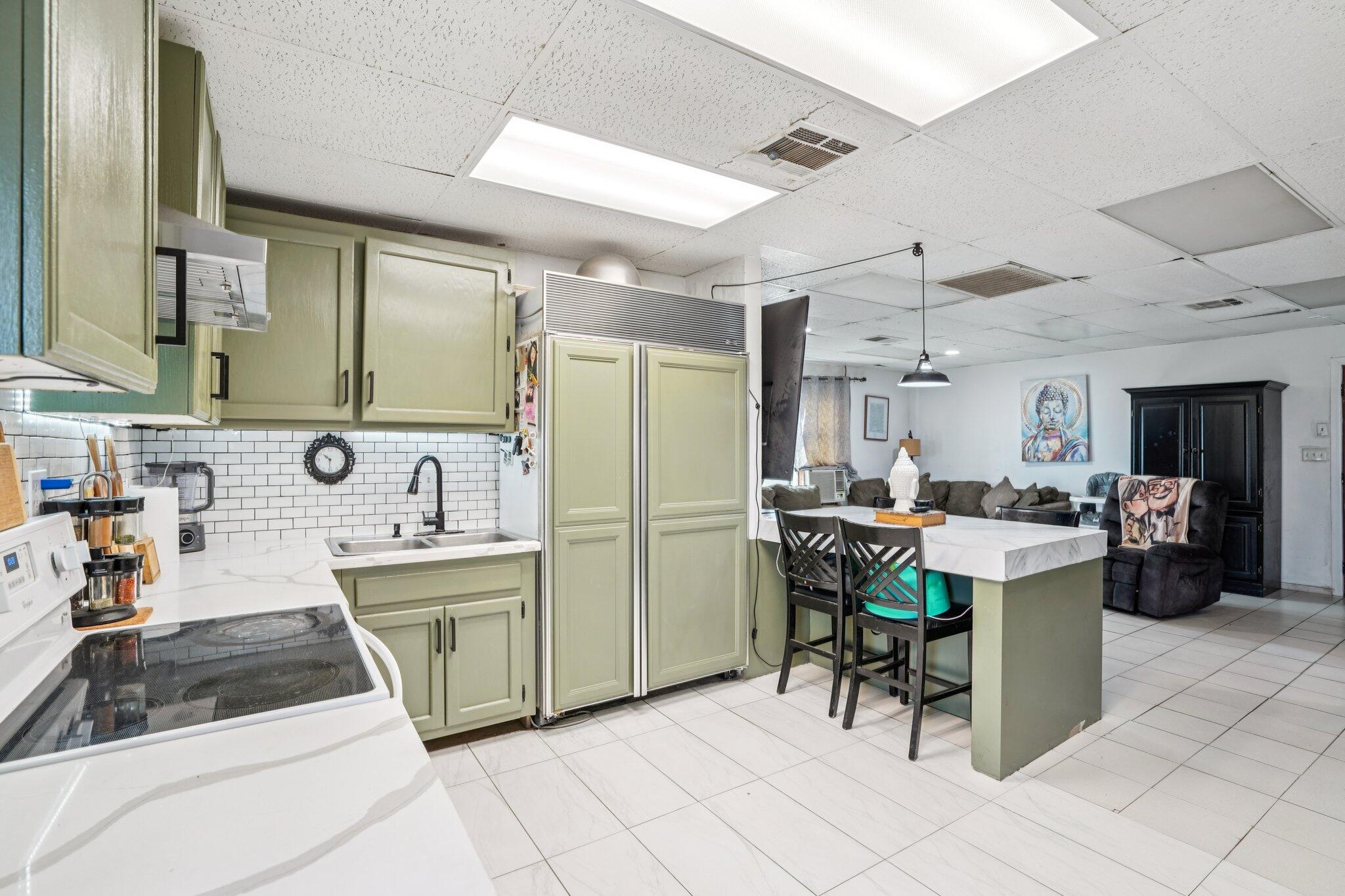 2154 Riviera Circle Thermal, CA 92274 - Photo 16 of 43 a kitchen with a sink and chairs