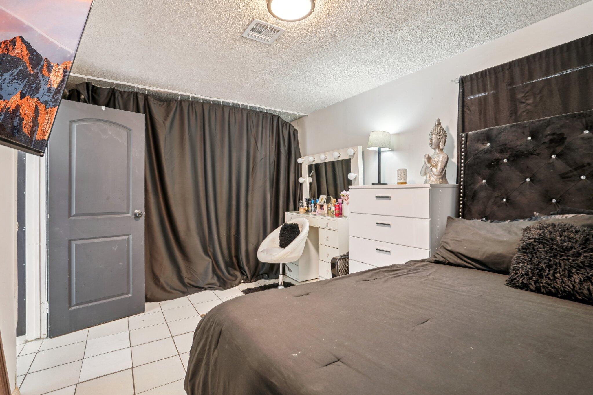 2154 Riviera Circle Thermal, CA 92274 - Photo 18 of 43 a bedroom with a bed and a refrigerator