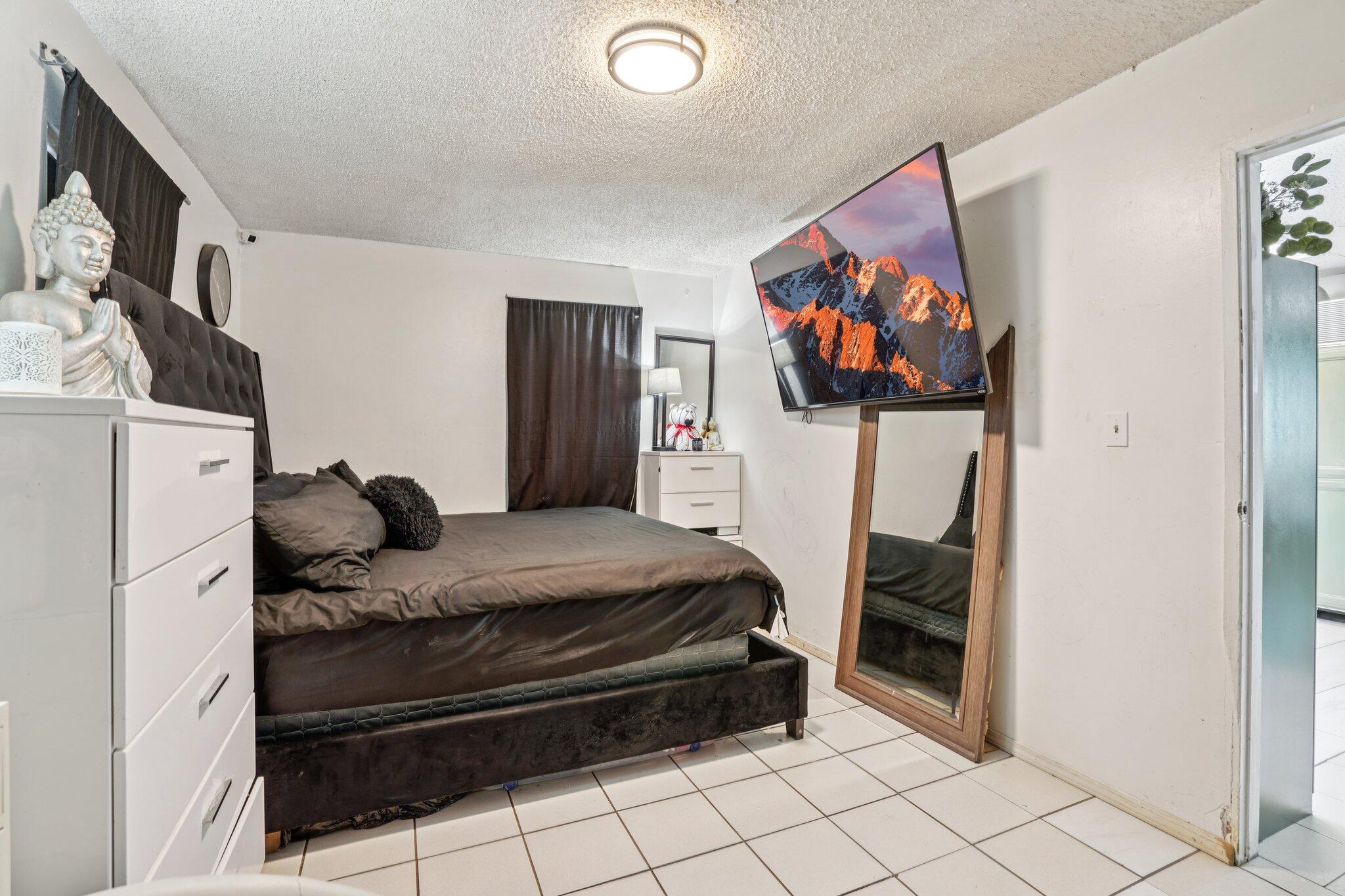 2154 Riviera Circle Thermal, CA 92274 - Photo 19 of 43 a bedroom with a bed and a painting on the wall